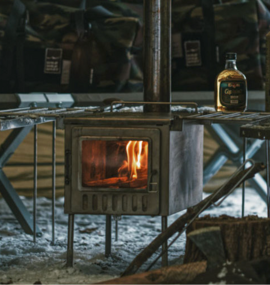 Xstove XL camping wood stove front window firewood burning with official Wild Wild West logo.