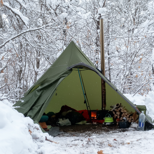 Backpacking titanium wood stove hot tent campsite in snow