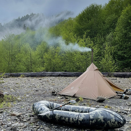 Backpacking hot tent with raft in forest campsite