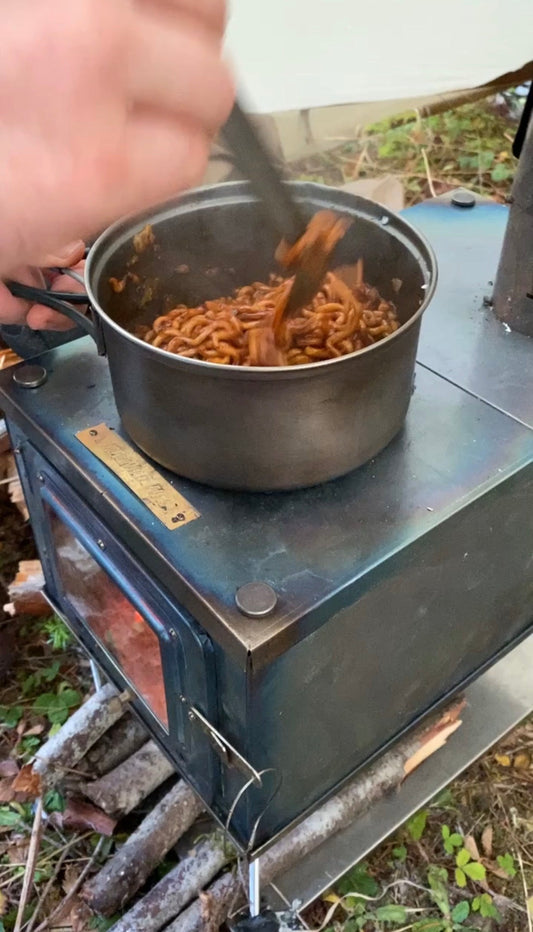 Cooking on a titanium tent wood stove while backpacking