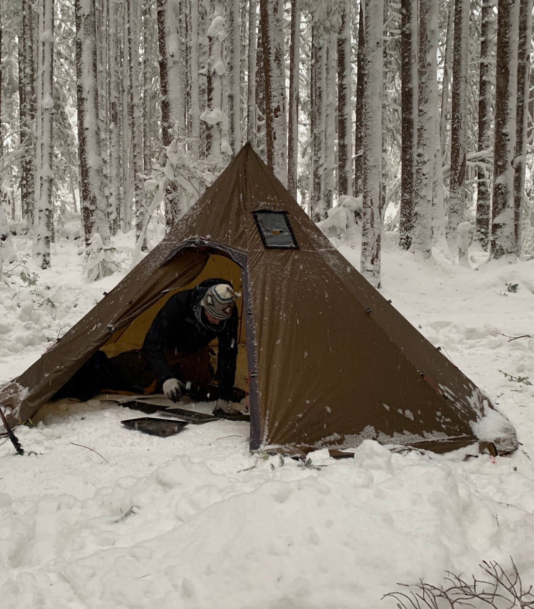Winter camping with a floorless tent and building a wood stove in camp