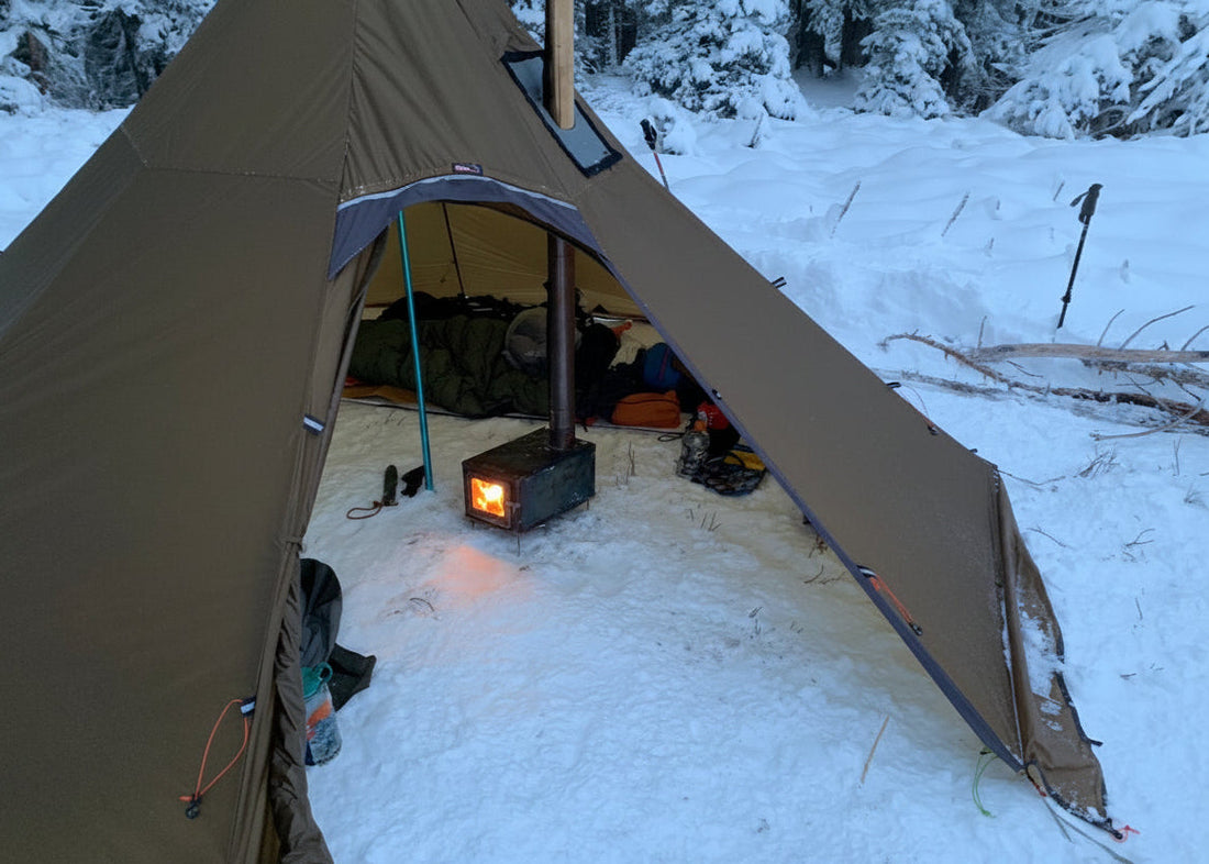 Floorless tent with wood stove camping in the backcountry
