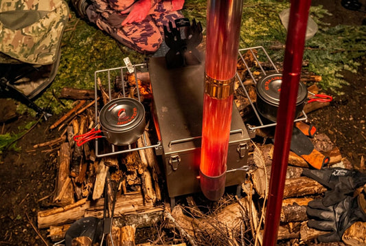 Winter camping with hot tent stove with pots and stacks of firewood