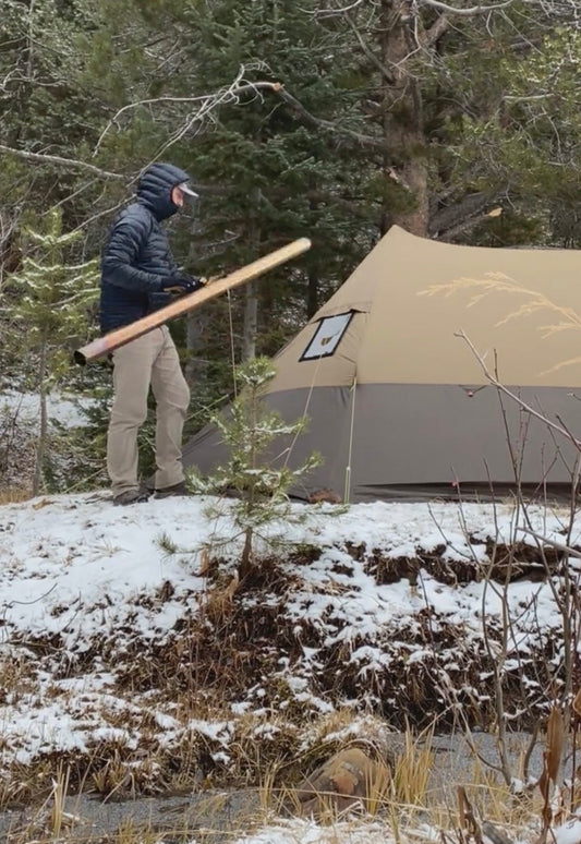 Installing a roll-up chimney pipe in a hot tent while winter camping 