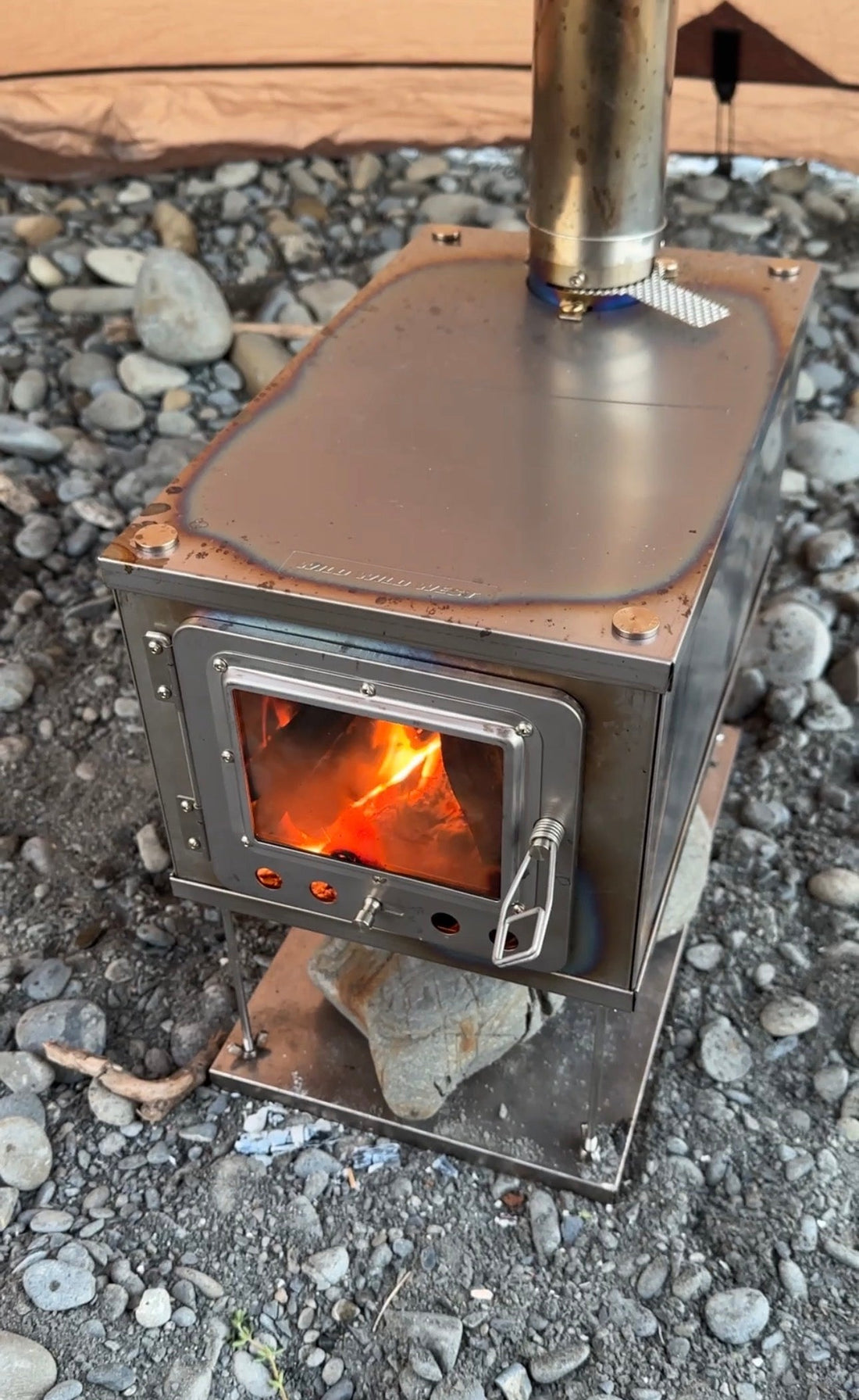 Fireplace glass as viewing window in tent wood stove