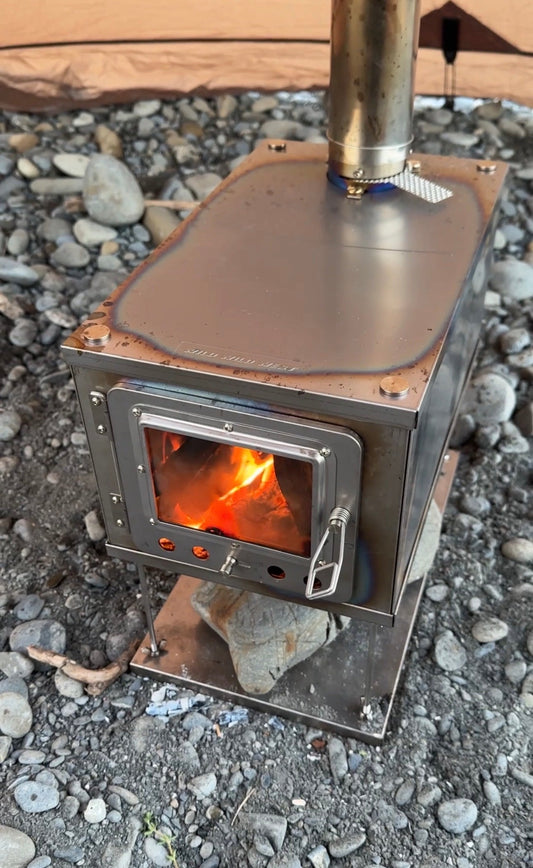 Fireplace glass as viewing window in tent wood stove