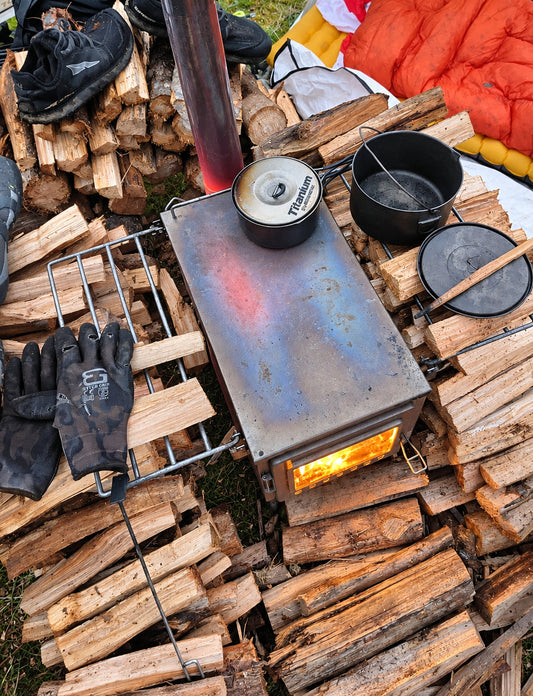 Firewood drying around tent wood stove