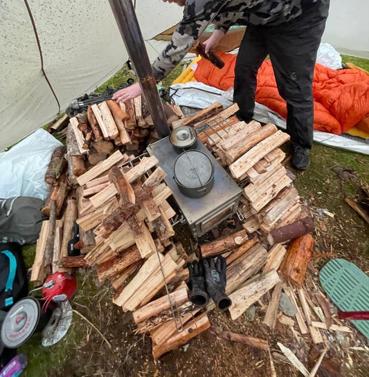 Drying wet firewood around a tent wood stove