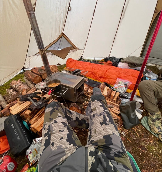 Drying wet gear wood stove inside tent while camping