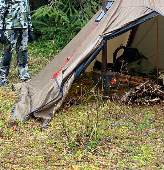 Titanium tent wood stove in hunting camp