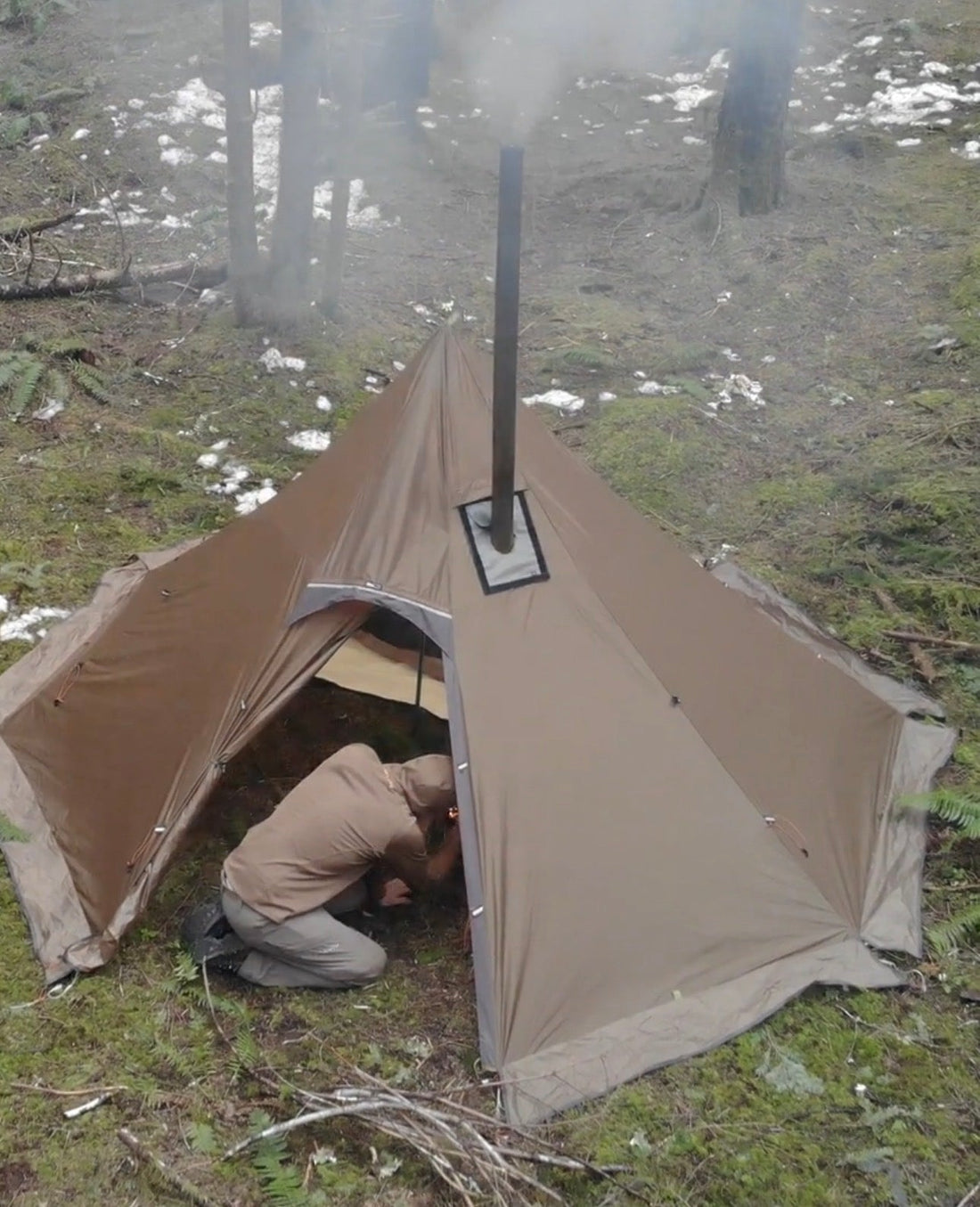 Ultralight hot tent with wood stove in a backcountry campsite in the forest