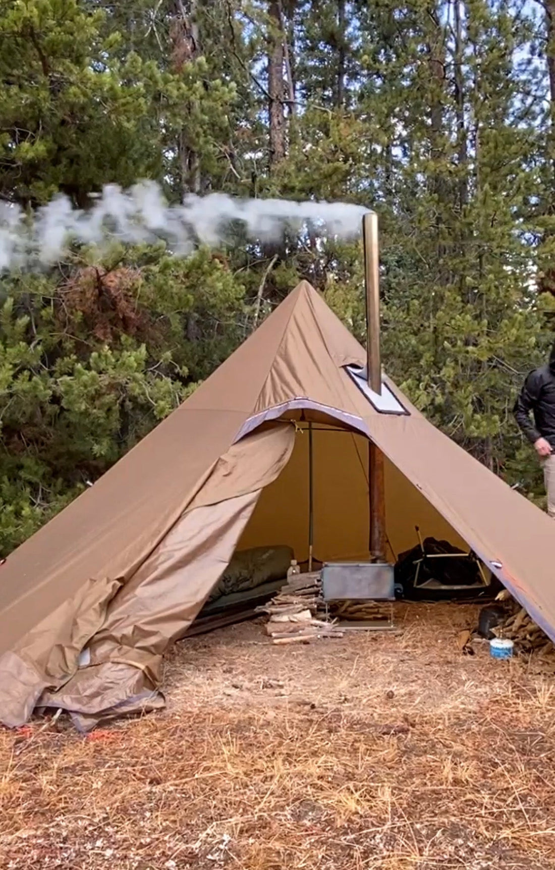 Windy backcountry campsite with tent wood stove