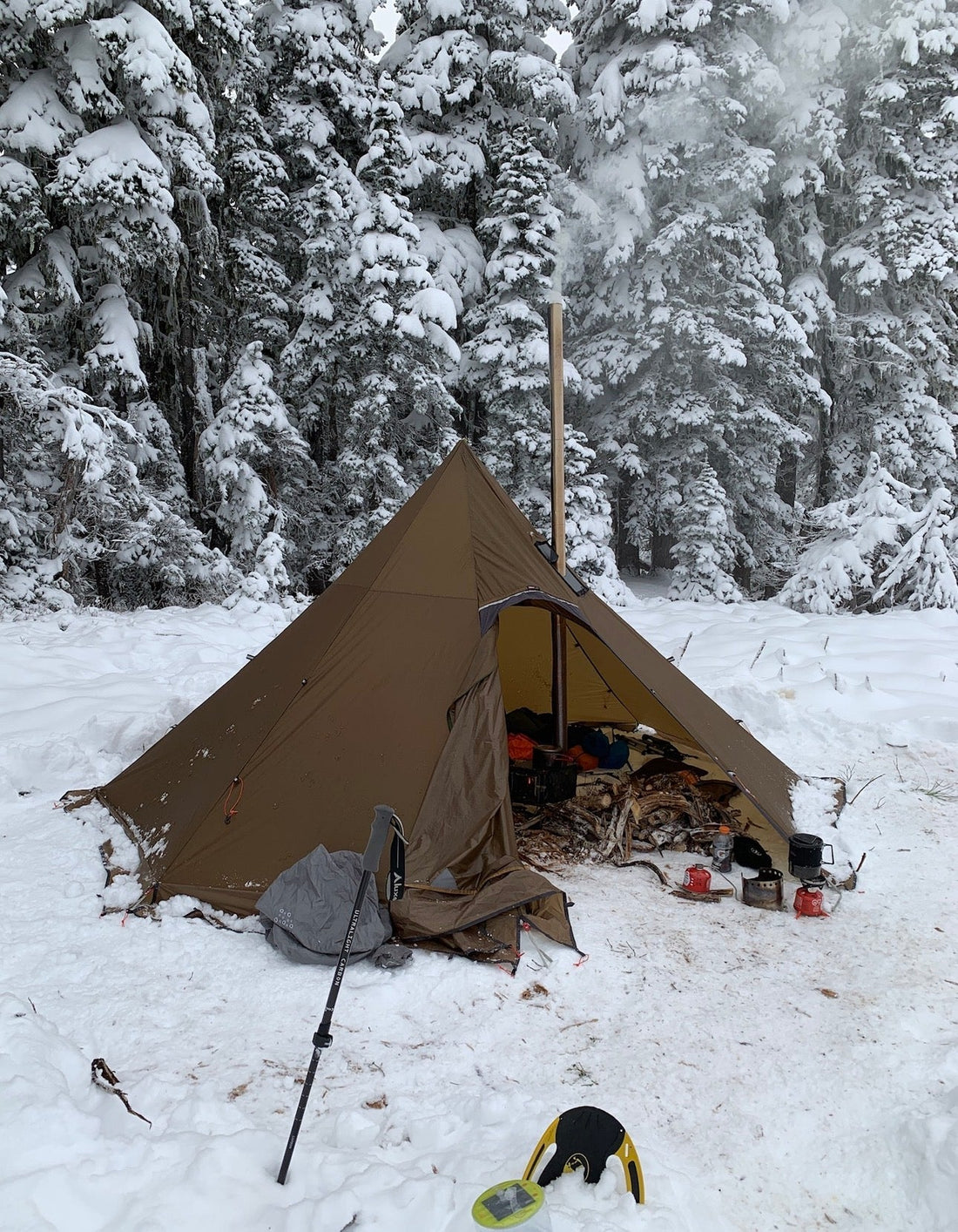 Winter camping in the mountains with tent wood stove