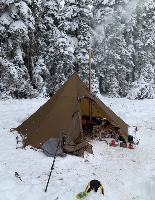 Winter camping in the mountains with tent wood stove