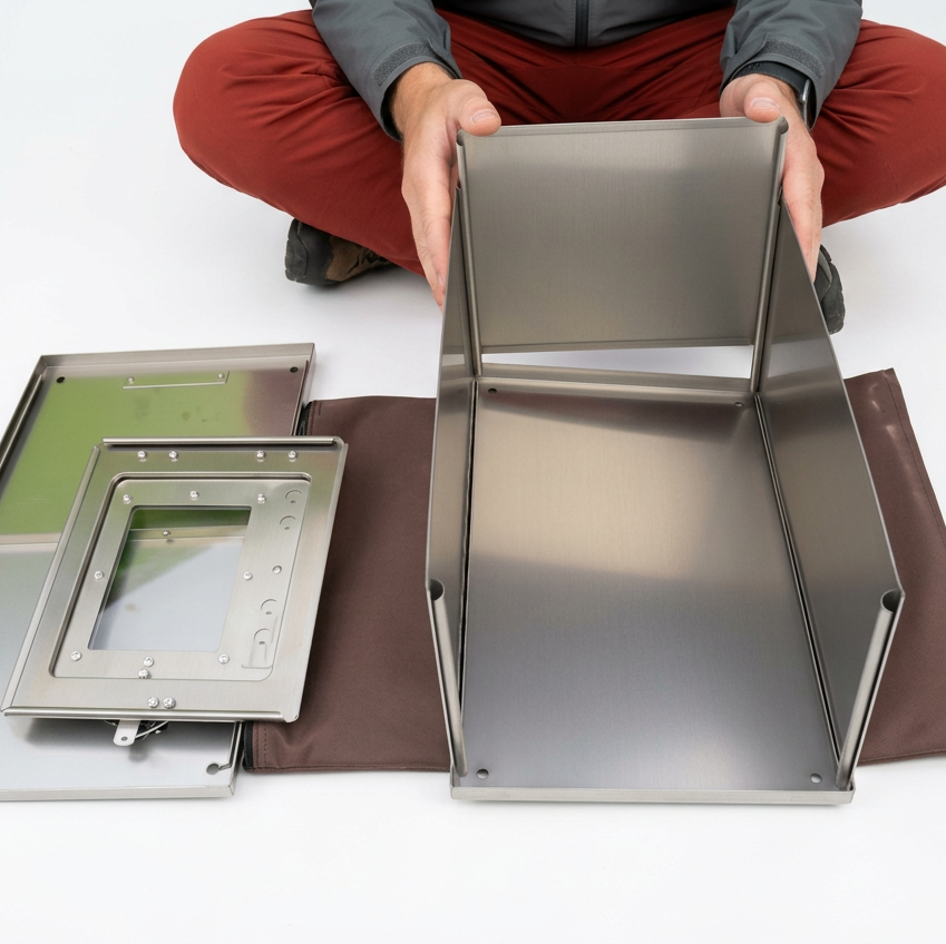 Titanium tent stove with locking anti-warp panels 