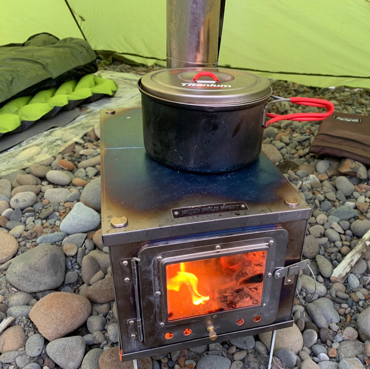 W-stove 3W Titanium Tent Stove with backpacking style pot on stovetop