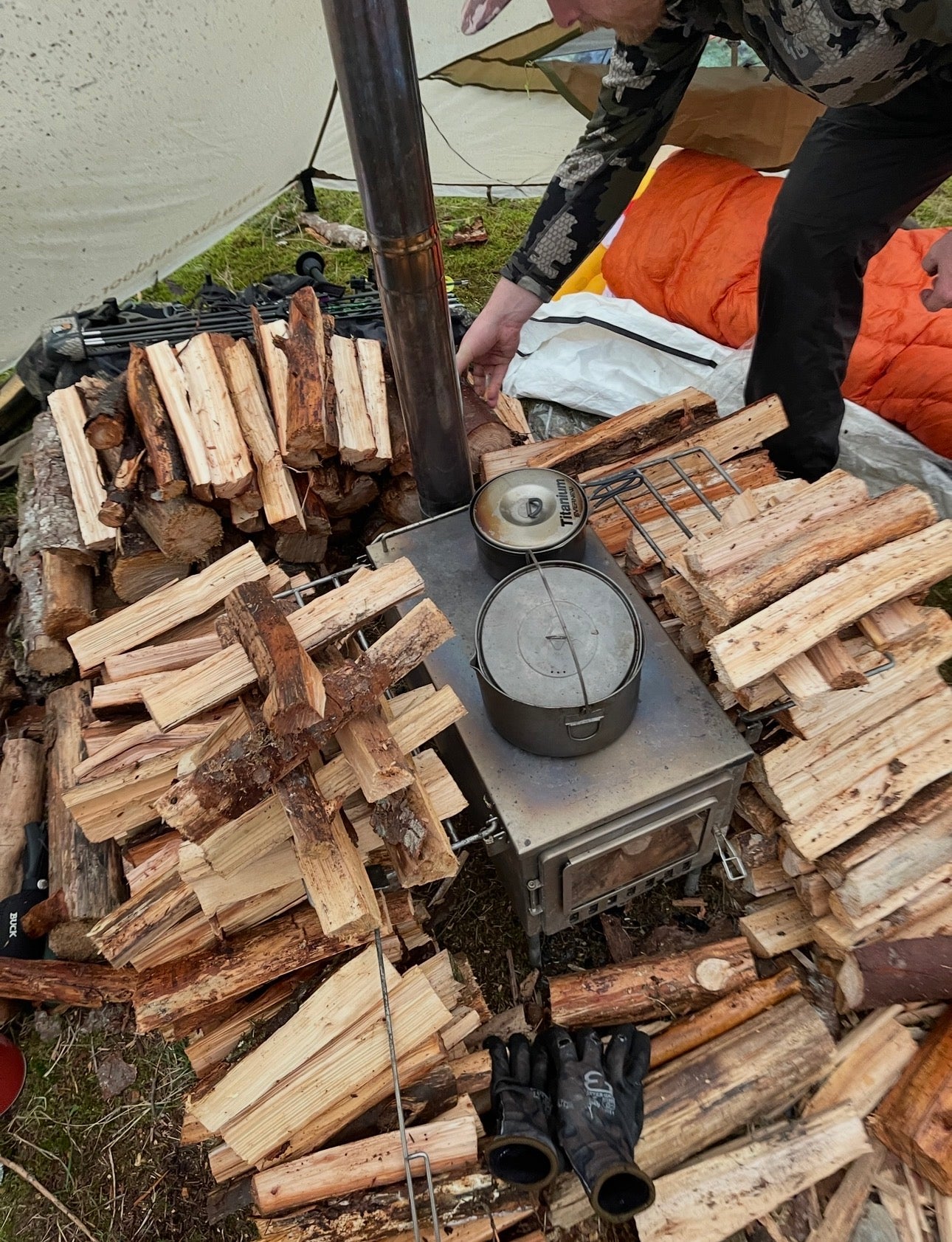 Wild Wild West Wood Stove with a stockpile of camp firewood