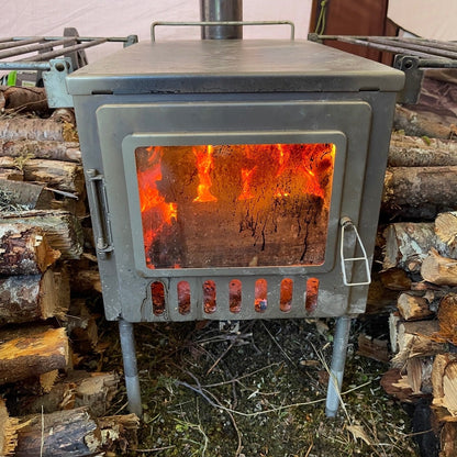X-stove XL Hot Tent Wood Stove with glass window and firewood stockpile around